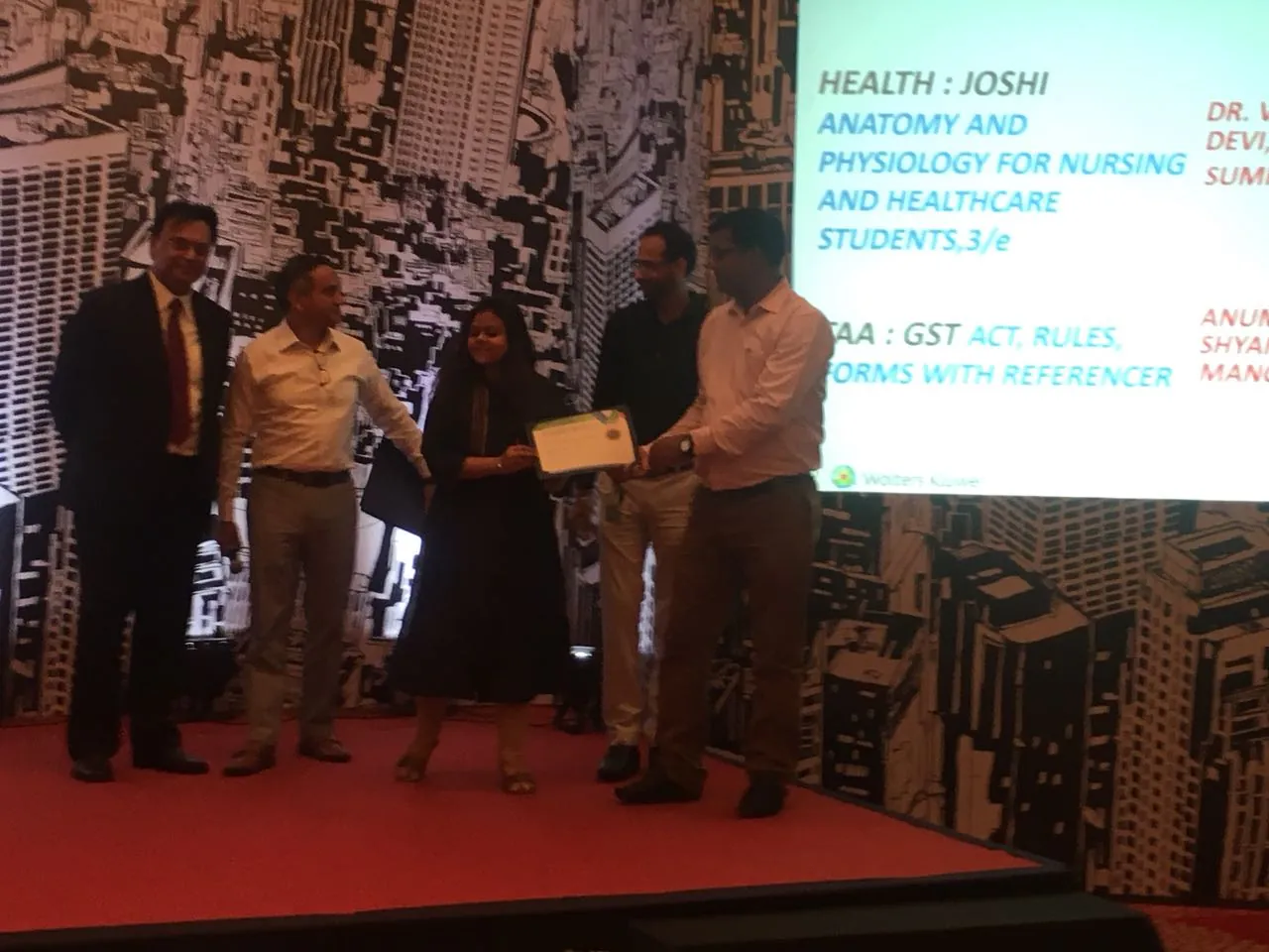 Receiving an award at a Wolters Kluwer India event